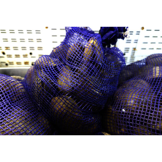 Blue mesh bags containing top-neck clams on a blurred background